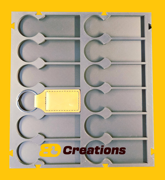 12-slot 6x2 leatherette keychain jig for laser engraving with a keychain blank in one slot